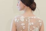 Hochzeitsfrisuren: Frau in Brautkleid von hinten und Chignon