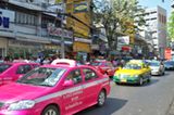 Durch die Straßen Bangkoks schlängeln sich bunte Taxis. Die Regierung stattet diese Autos mit umweltfreundlichen Gasmotoren aus. Aber natürlich hängt trotz allem immer der dichte Smog über der Stadt.
