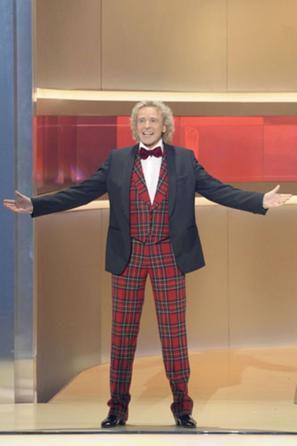 Thomas Gottschalk in einem typischen TV-Outfit. Eine Hommage an die Looks alter Showmaster, die gern in grell bunten, gemusterten Anzügen auftraten (karierte Anzüge waren besonders beliebt).