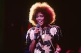 Whitney Houston trägt eine Pailletten-Bluse auf der Bühne