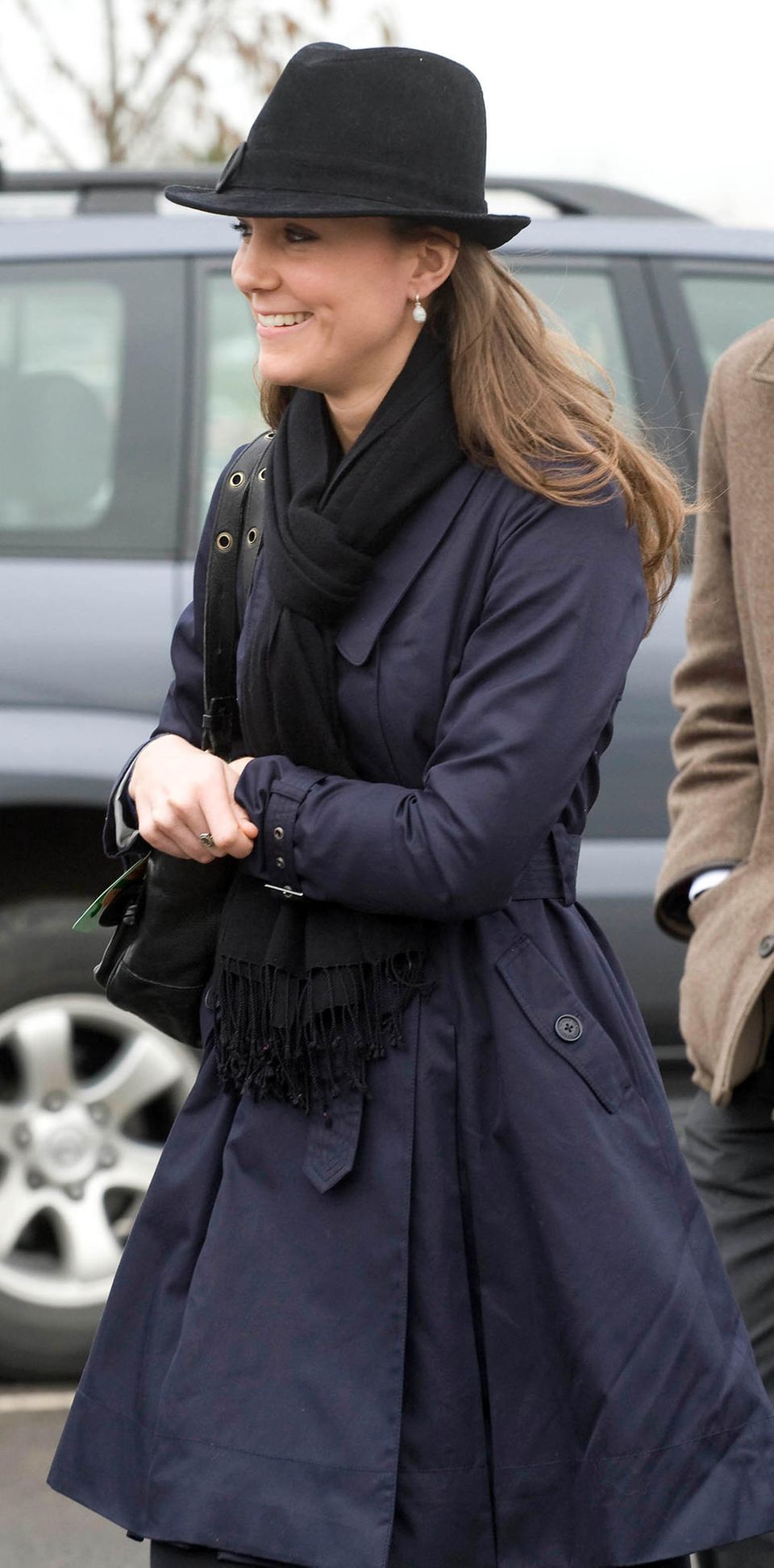 Kate Middleton mit Trenchcoat und Hut im Jahr 2008