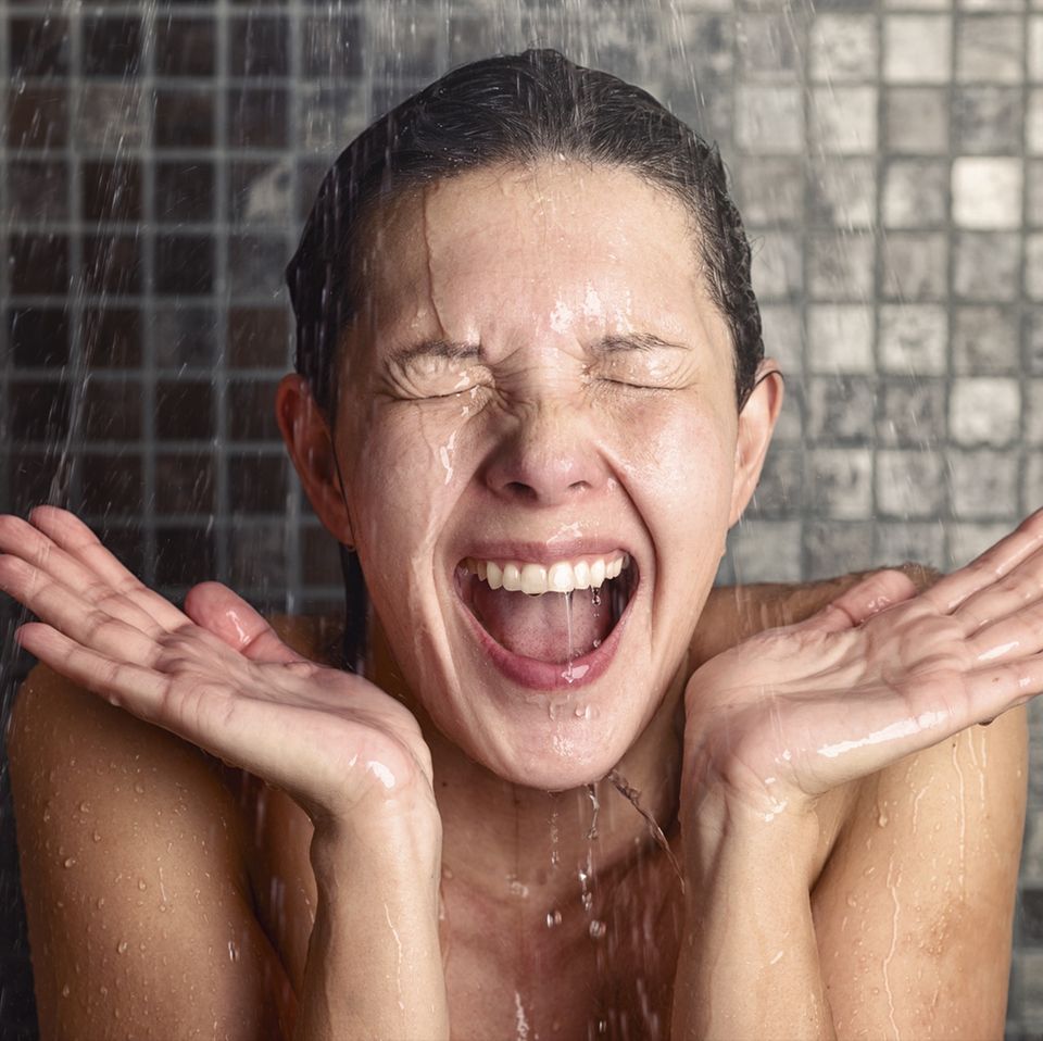 Frau duscht unter der Dusche