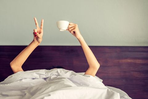 Schlecht geschlafen letzte Nacht? Frau mit Kaffeetasse im Bett (Symbolbild)