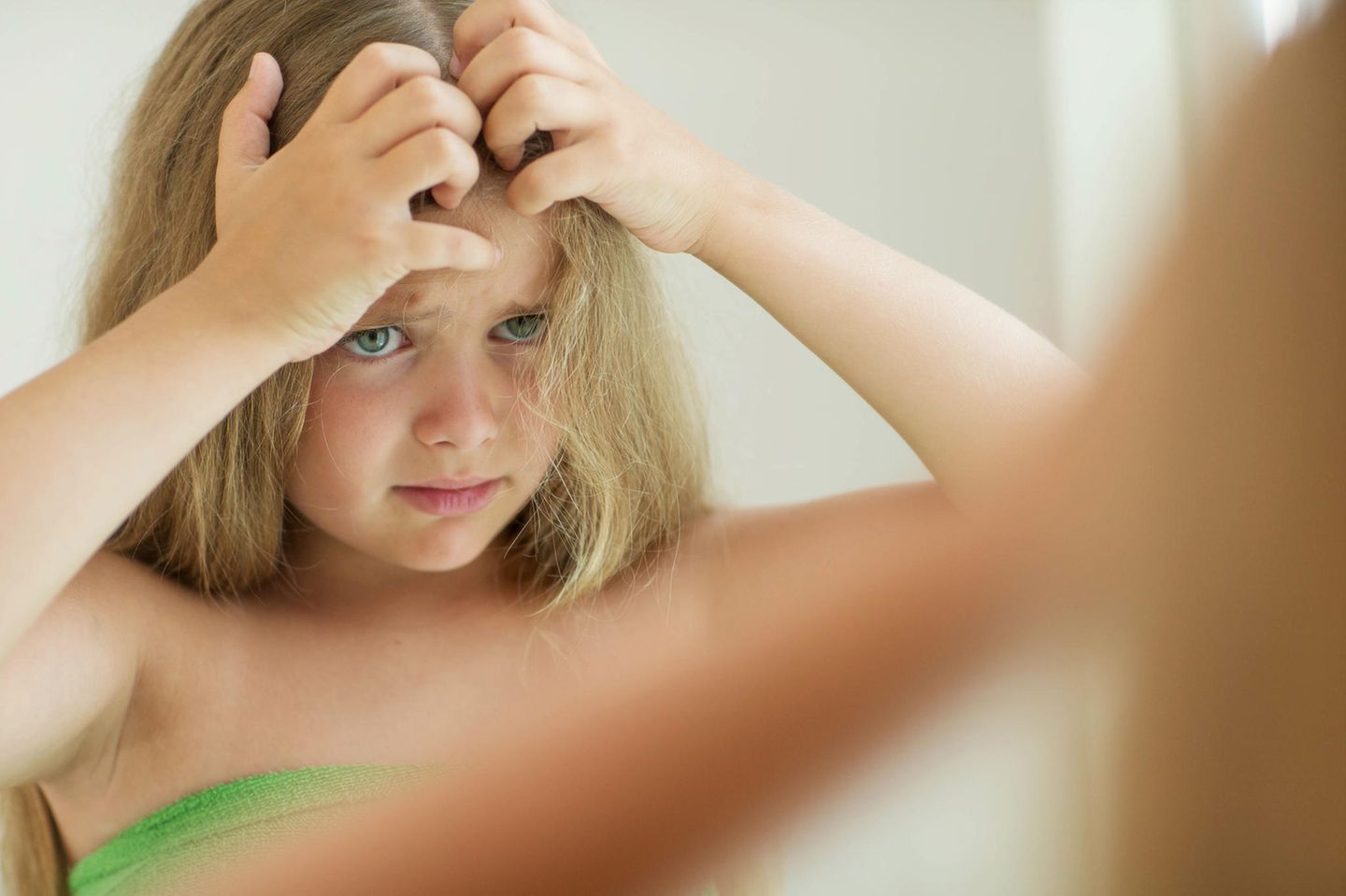 Kopfläuse: Mädchen kratzt seinen Kopf