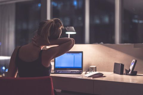 Burnout vermeiden: Müde Frau sitzt am Laptop