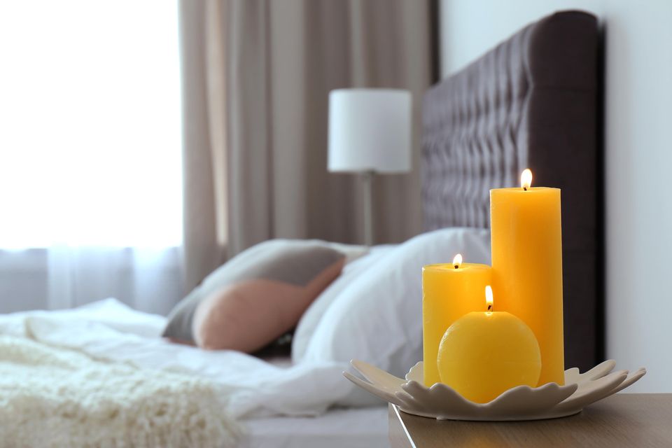 Tricks, die dein Schlafzimmer gemütlicher machen: Gelbe Kerzen am Bett