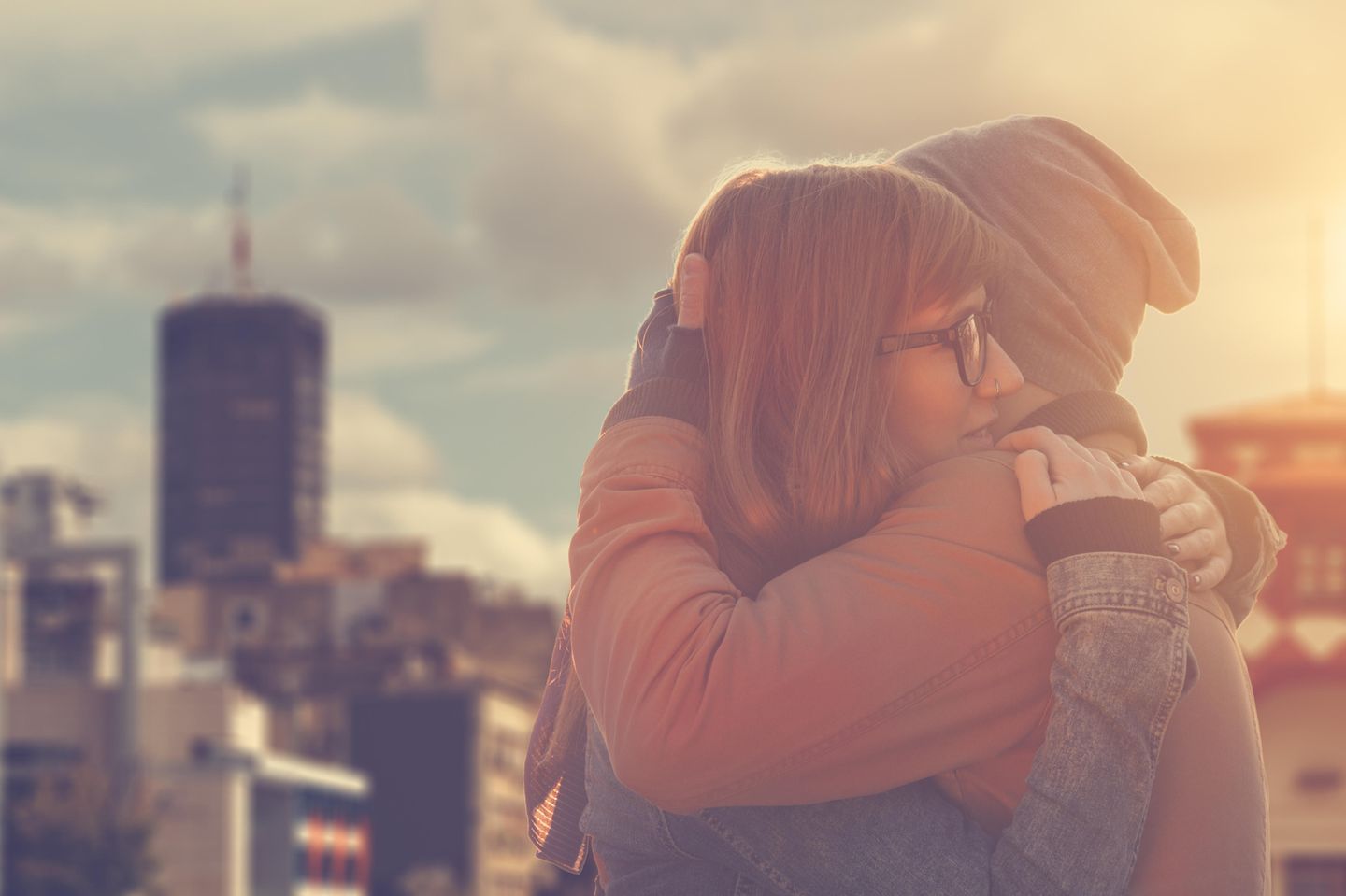 Emotionale Affäre: Mann und Frau umarmen sich vertraut auf einem Hausdach