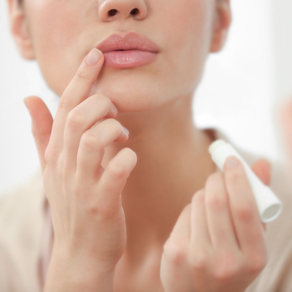 Lippenpflege: Frau trägt Lippenpflegestift auf