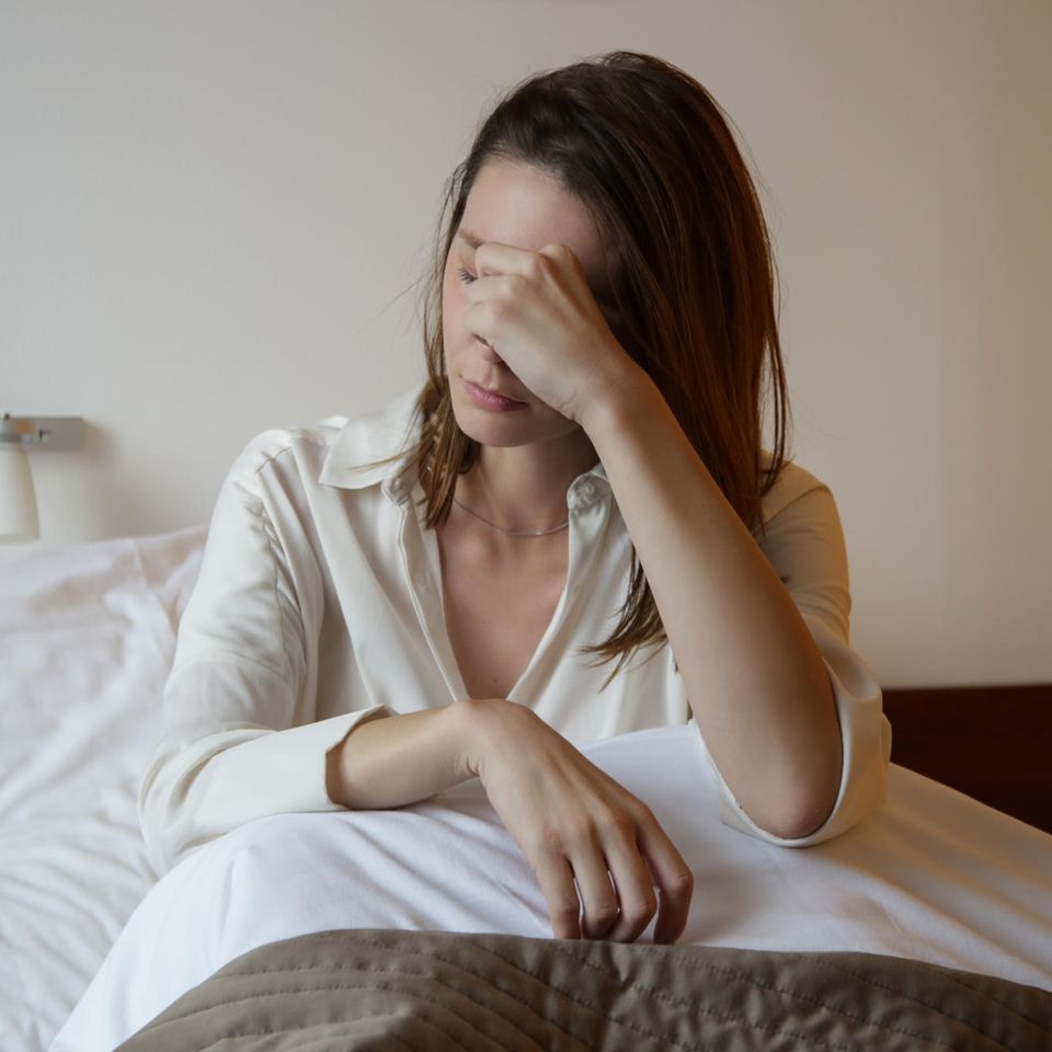 Niedriger Blutdruck: Hausmittel: Müde Frau im Bett