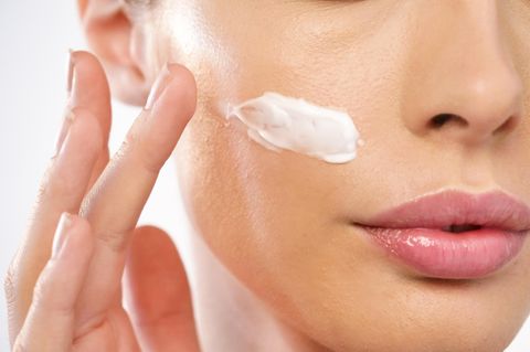 SOS-Tipps für zickige Haut: Frau cremt sich das Gesicht ein