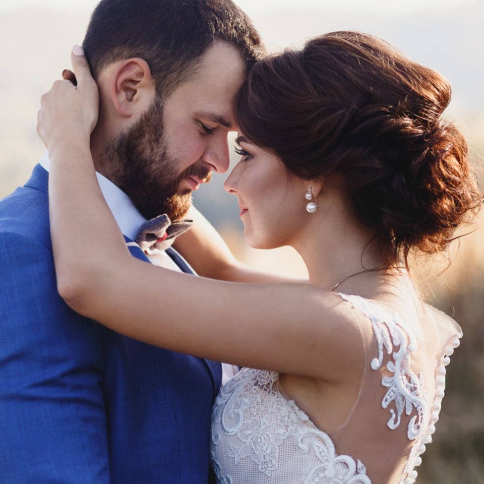 Eheversprechen: praktische Tipps und Beispiele: Brautpaar umarmt sich und sieht sich innig an