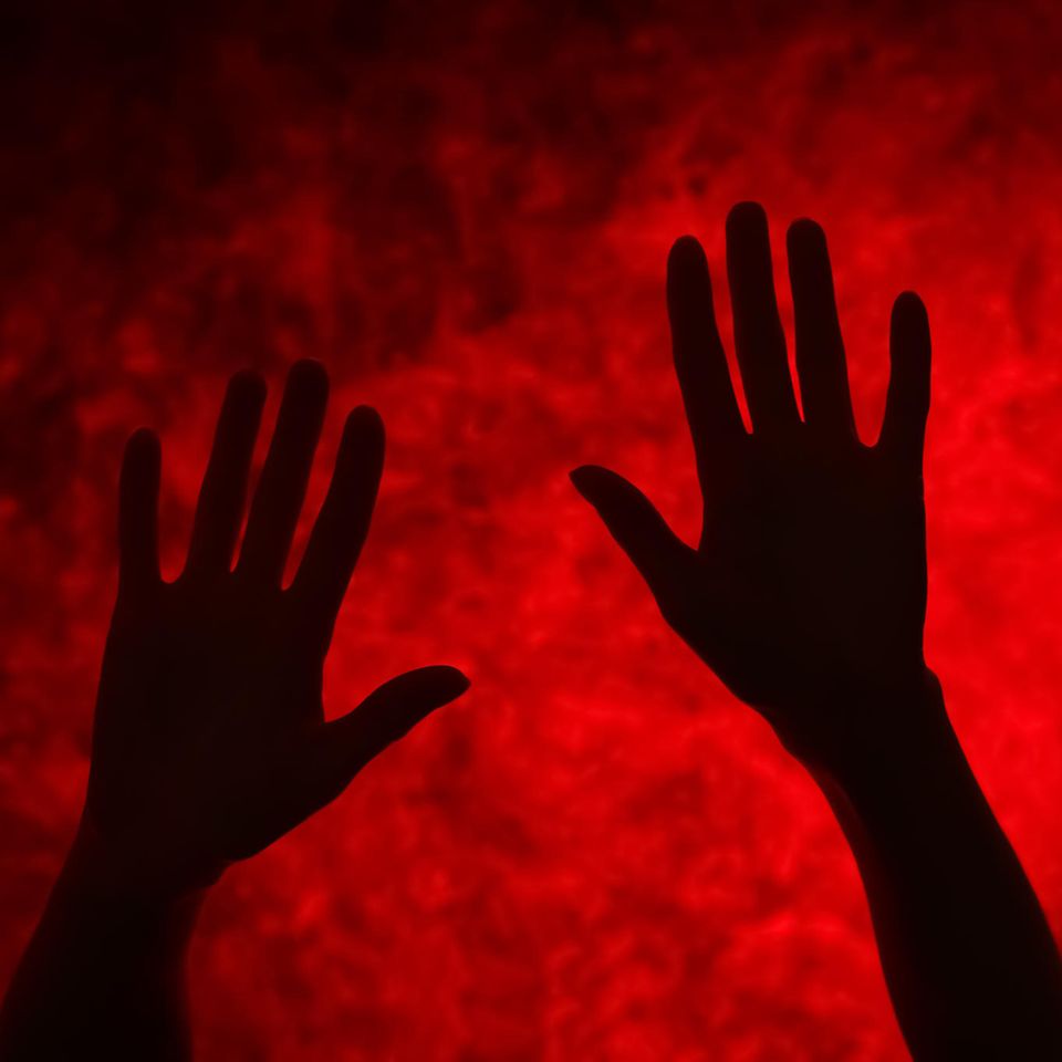 Blutvergiftung: Hände vor rotem Hintergrund