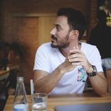 Was stört Männer an perfekten Frauen? Ein Mann sitzt allein an einem Tisch und schaut zur Seite