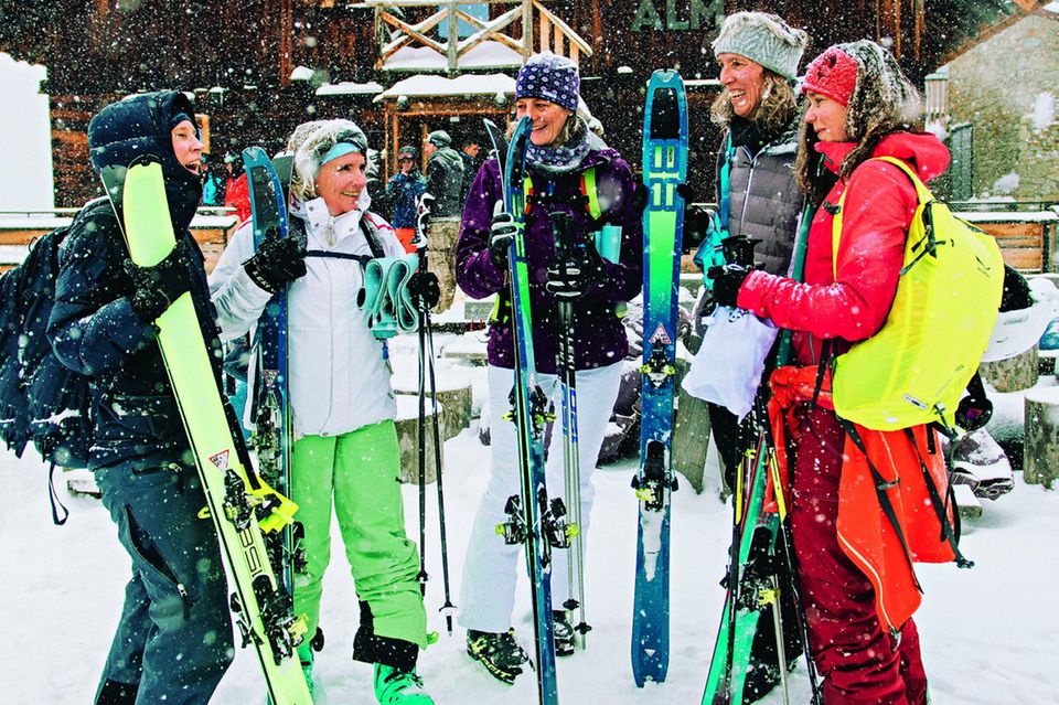 Klassenreise in den Schnee?: Frauen mit Skiern vor Almhütte