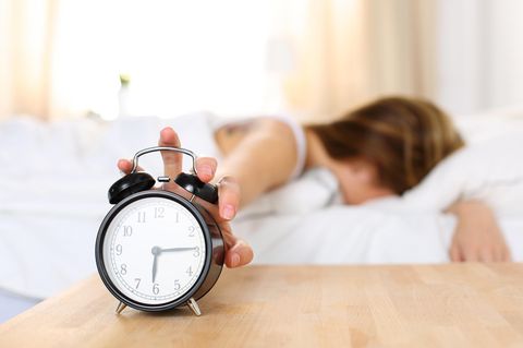 Optimale Schlafenszeit: Frau versucht, Wecker auszuschalten