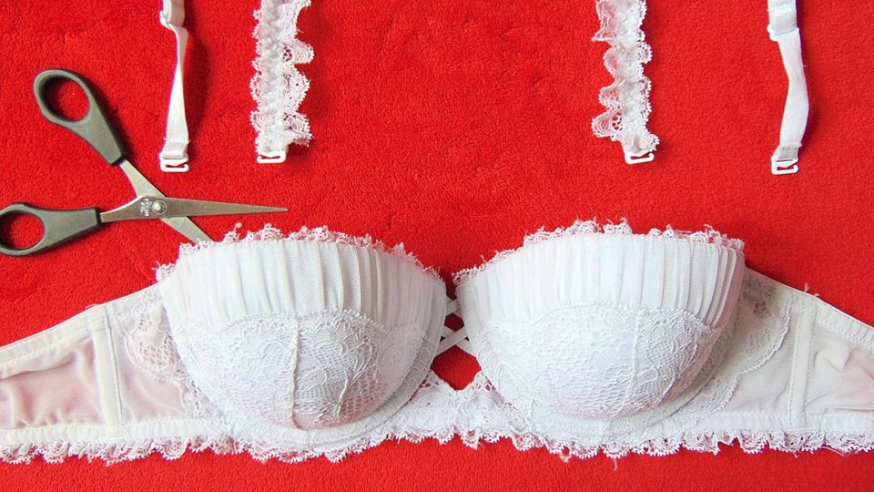 White bra on a red background with cut straps