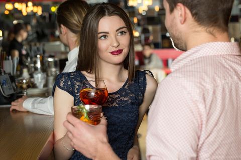 Frau flirtet mit Mann in Bar
