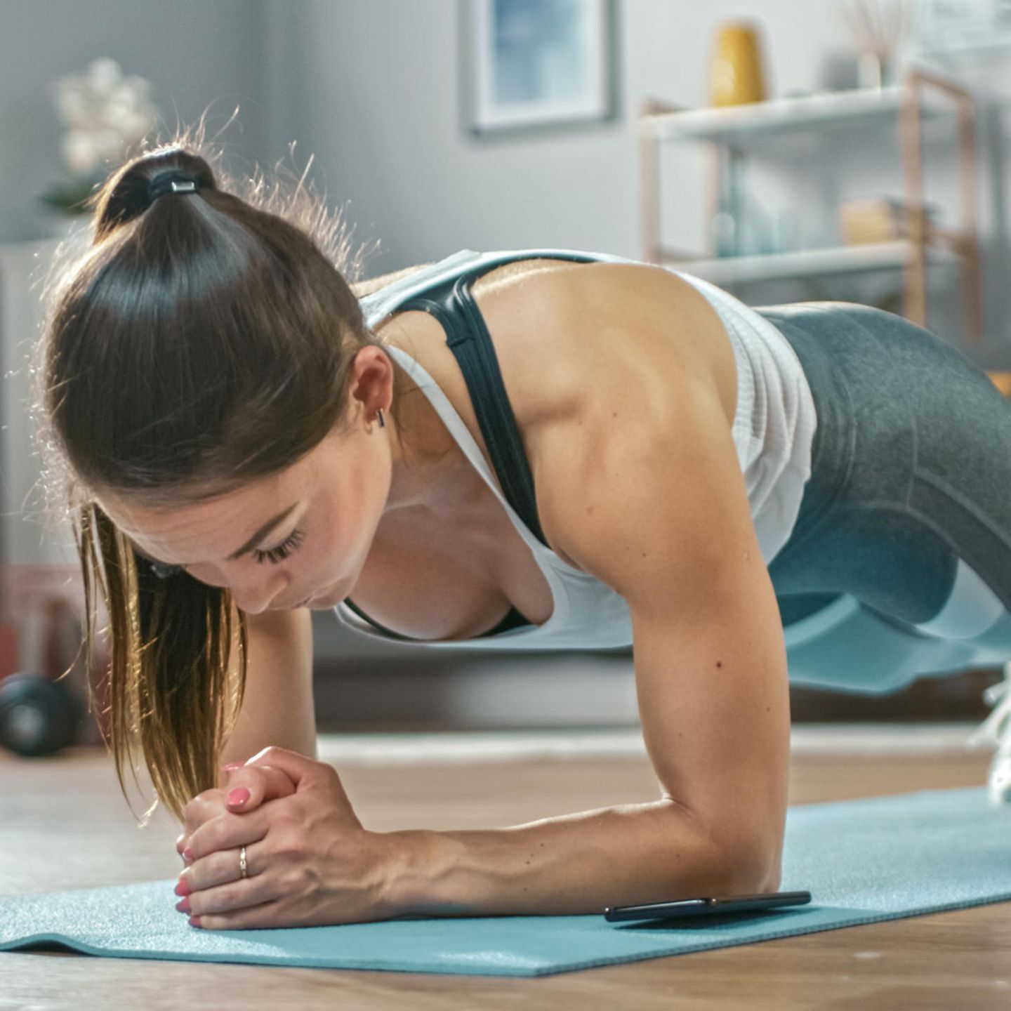 Weight training at home: plank, young woman, home workout, fitness at home