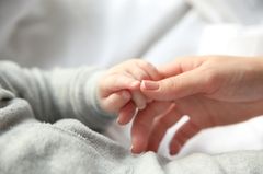 Breastfeeding ritual breastfeeding: baby hand in mother's hand