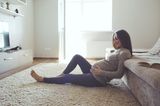 Weg mit den Schuldgefühlen!: Schwangere ruht sich in Wohnzimmer aus