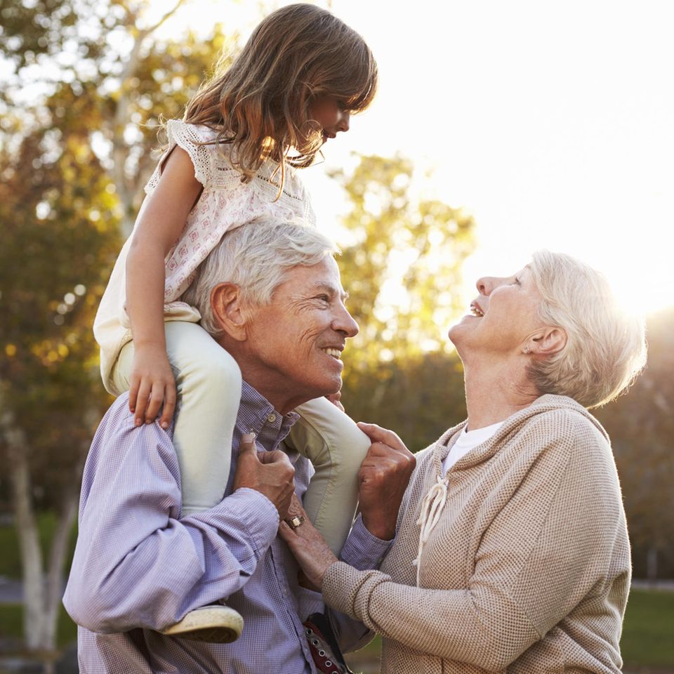 Großeltern mit Enkelkind auf Schultern des Opas