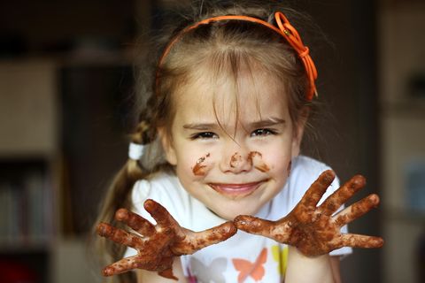 Körbchen-Trick: Mädchen zeigt Hände voller Schokolade