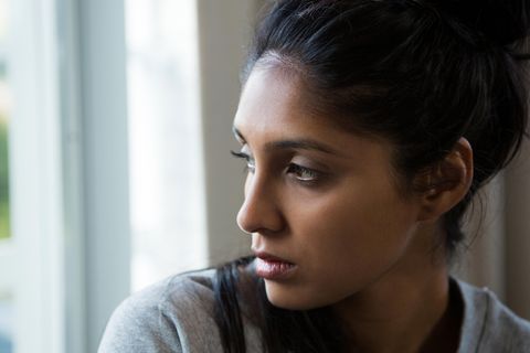 Frauenfeindliche Gesetze: Eine indische Frau schaut traurig aus dem Fenster