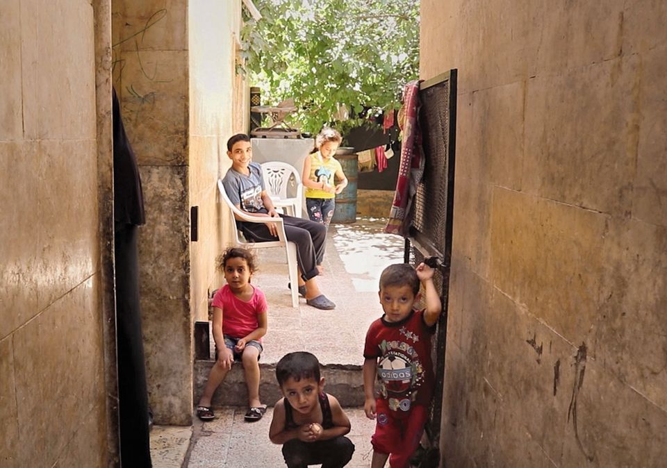 Ein Schal fürs Leben: Kinder vor einem Abbruchhaus
