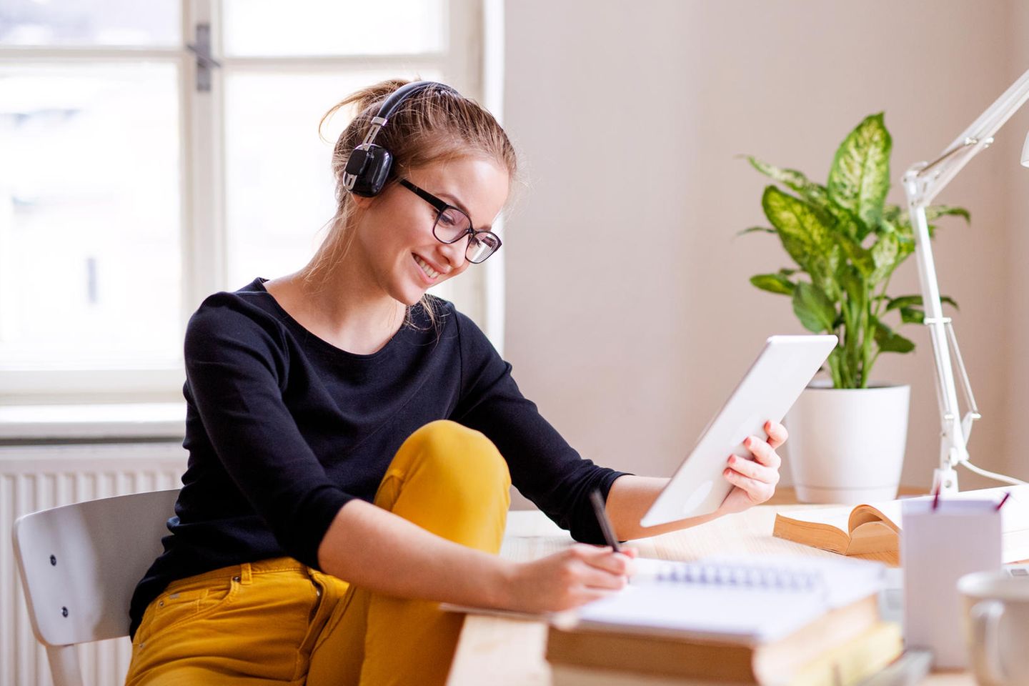 Haptic learner type: woman sits at a desk and works