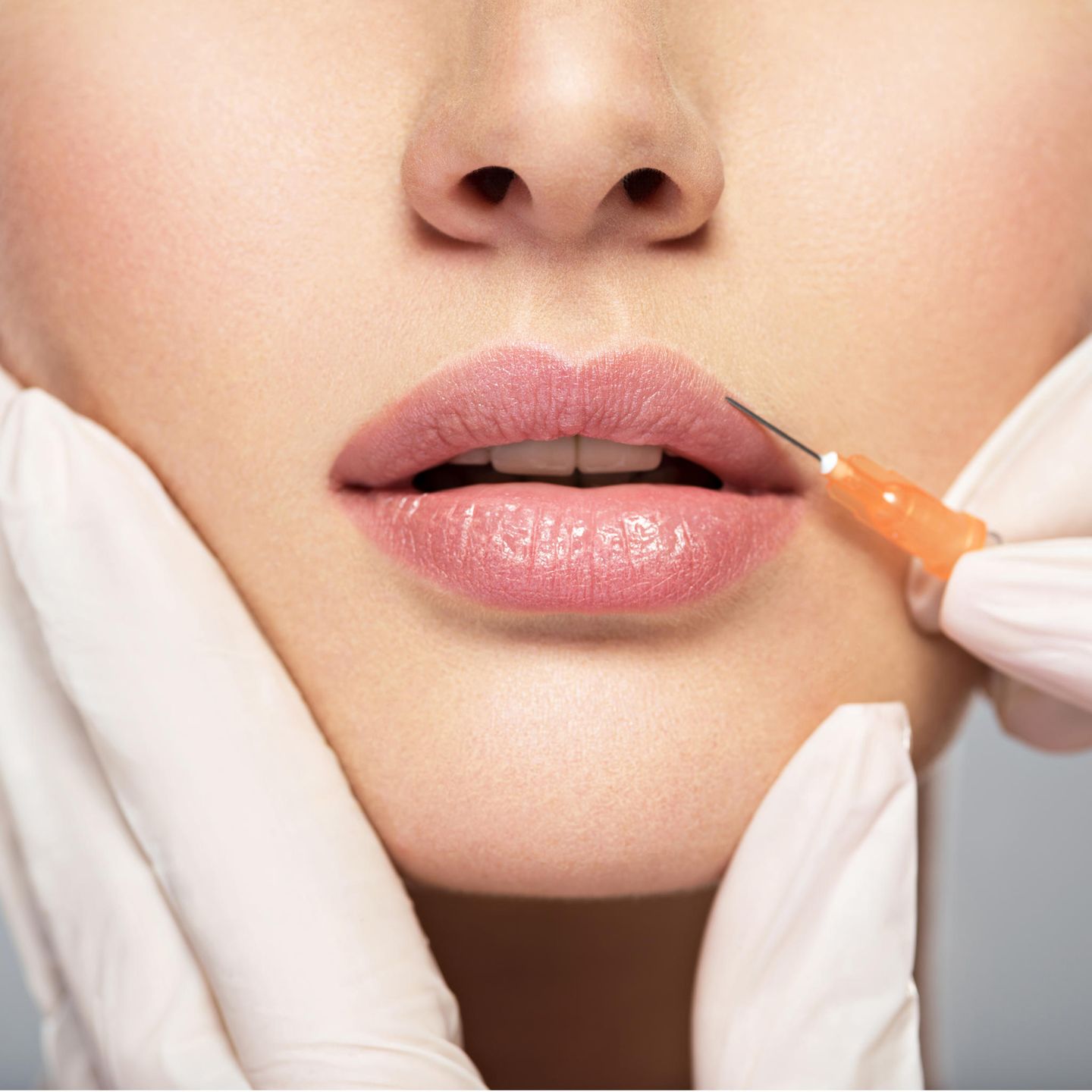 Beauty operation: syringe on woman's lip