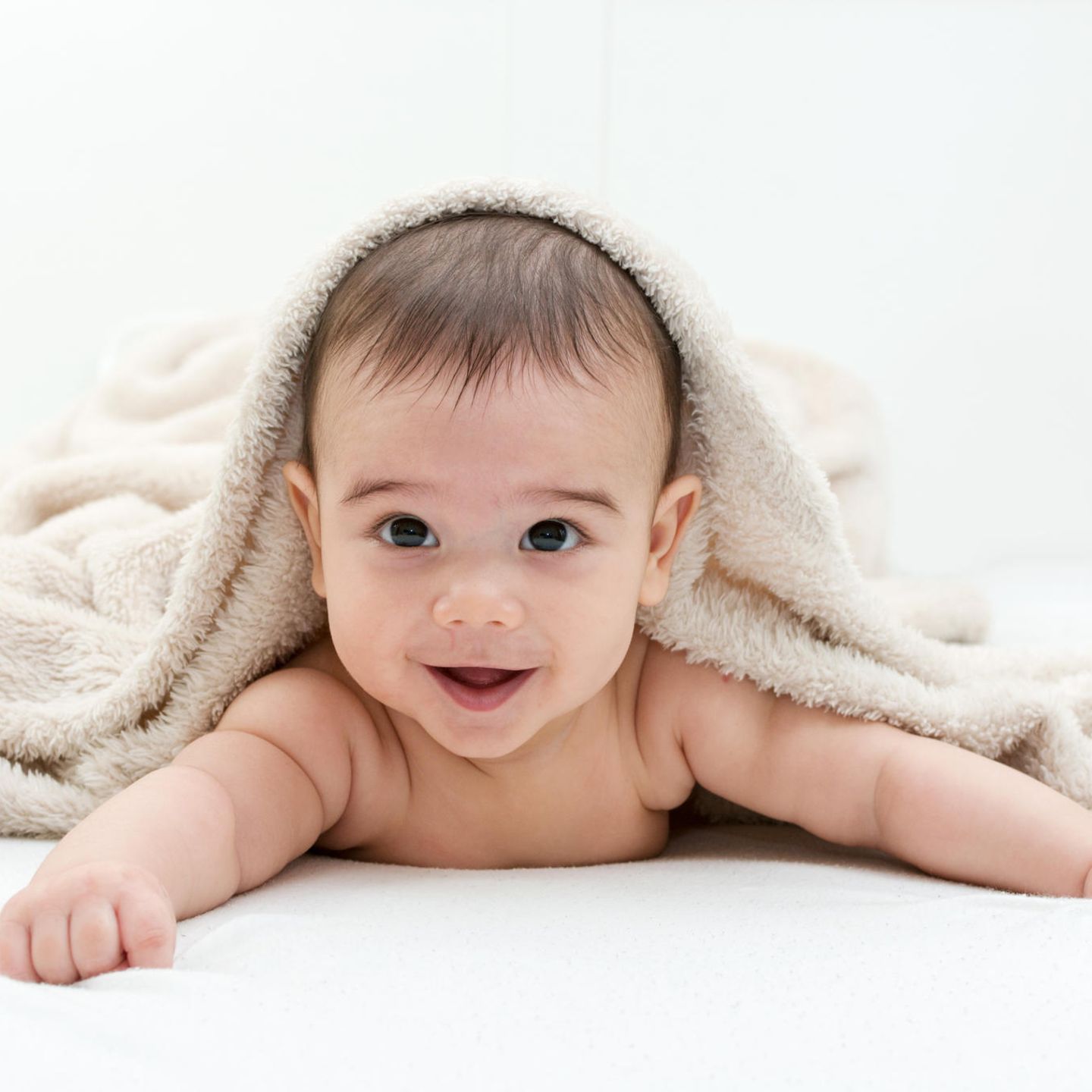 Liebevolle Babynamen: Baby mit Decke auf dem Kopf