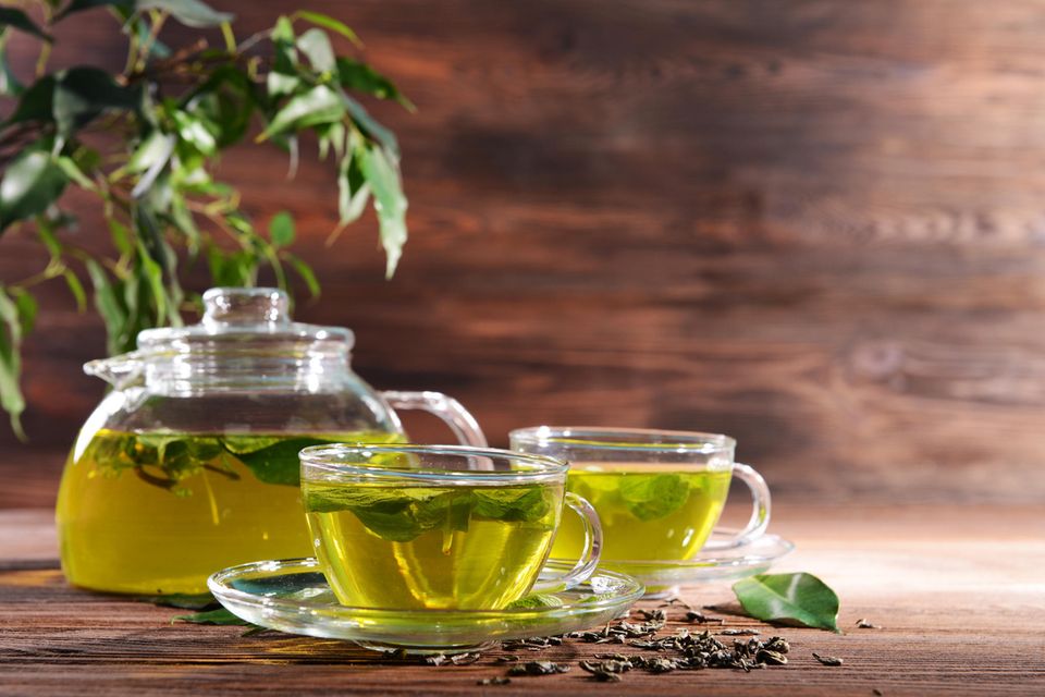 Grüner Tee: Glasbecher und Glaskanne mit gesundem grünen Tee