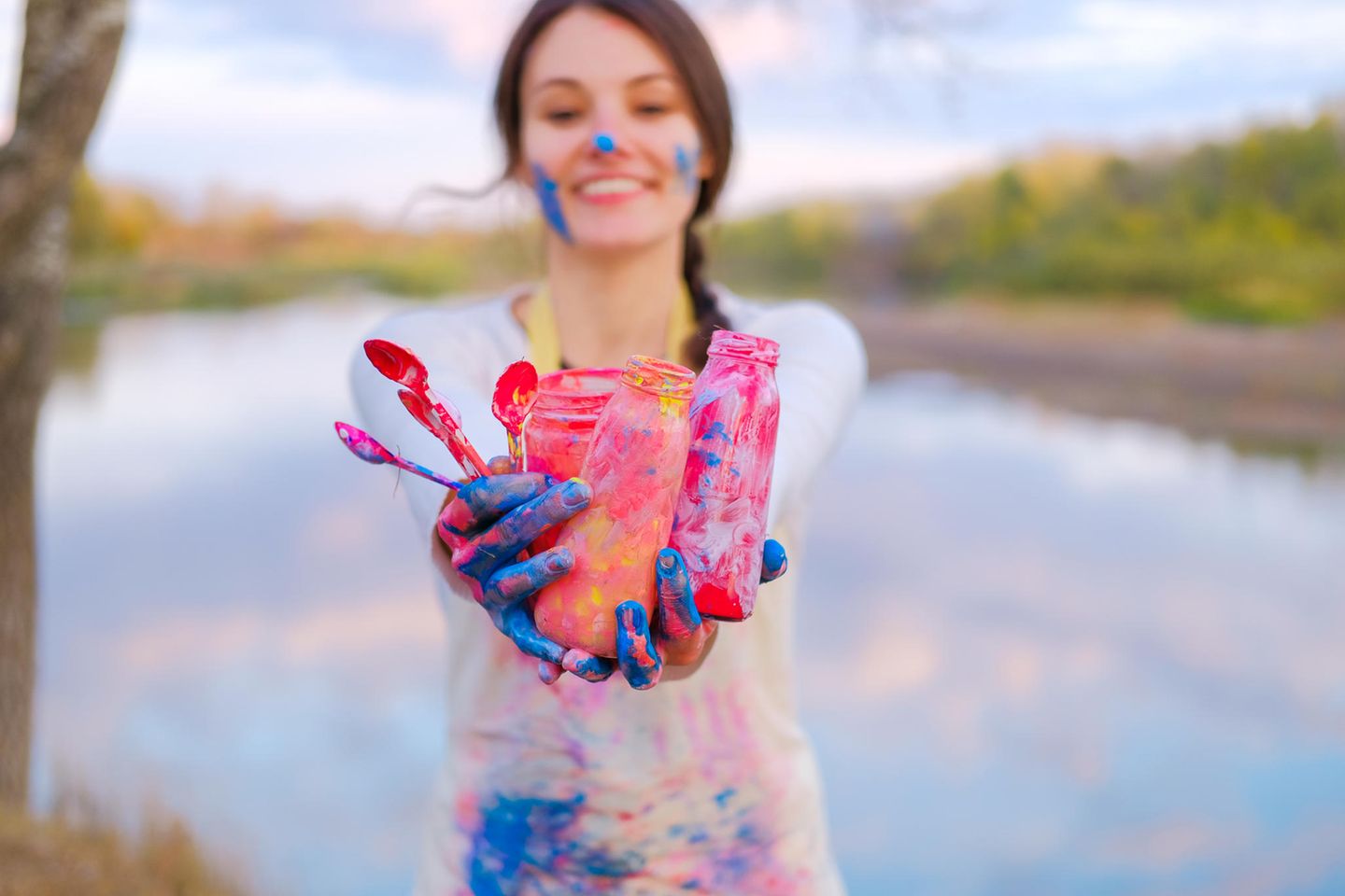 Acrylfarbe entfernen: Frau mit Acrylfarbe an Händen und auf Schürze
