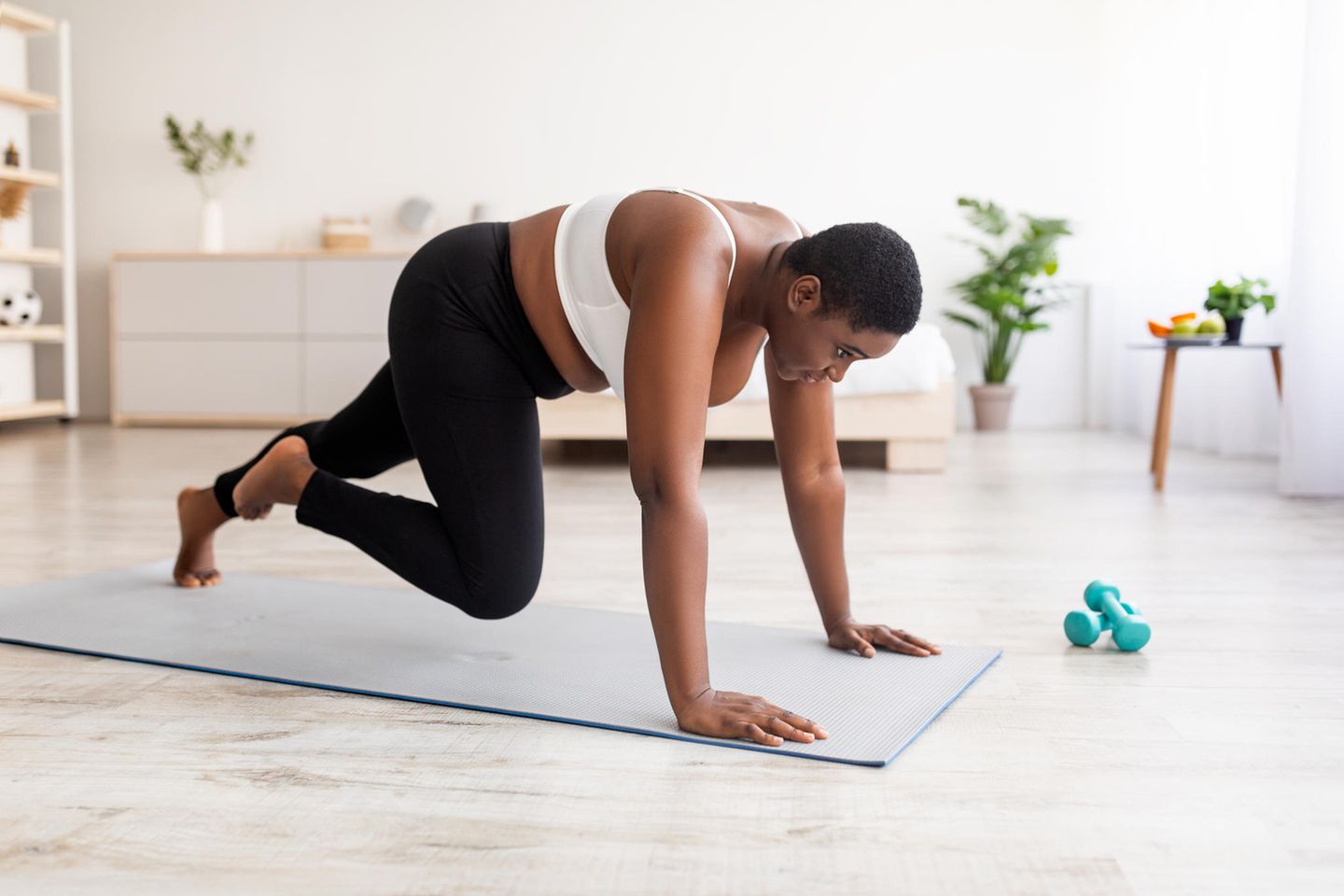 woman exercising on mat