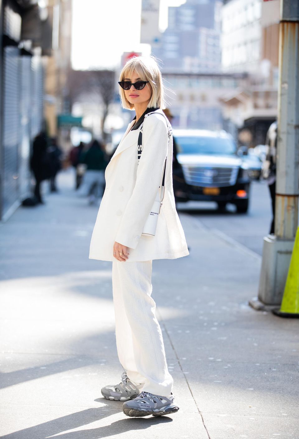 Xenia Adonts demonstrates where a white linen suit works well with chunky sneakers. 