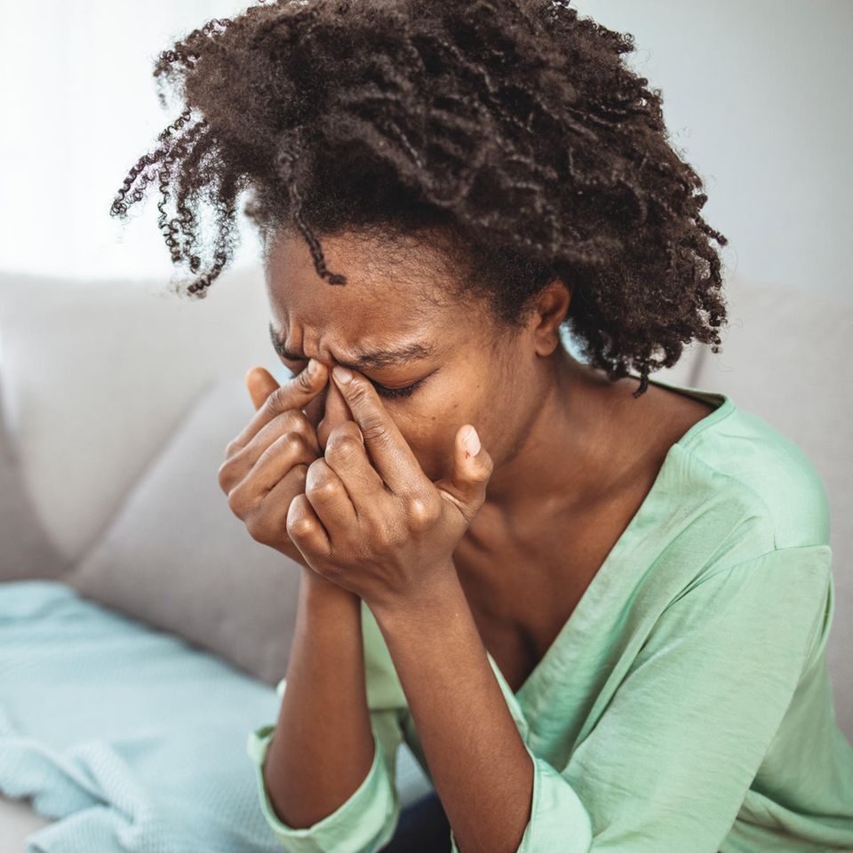 Frau mit Kofpschmerzen: Was du laut der 10-20-Regel bei der Einnahme von Schmerzmitteln beachten solltest