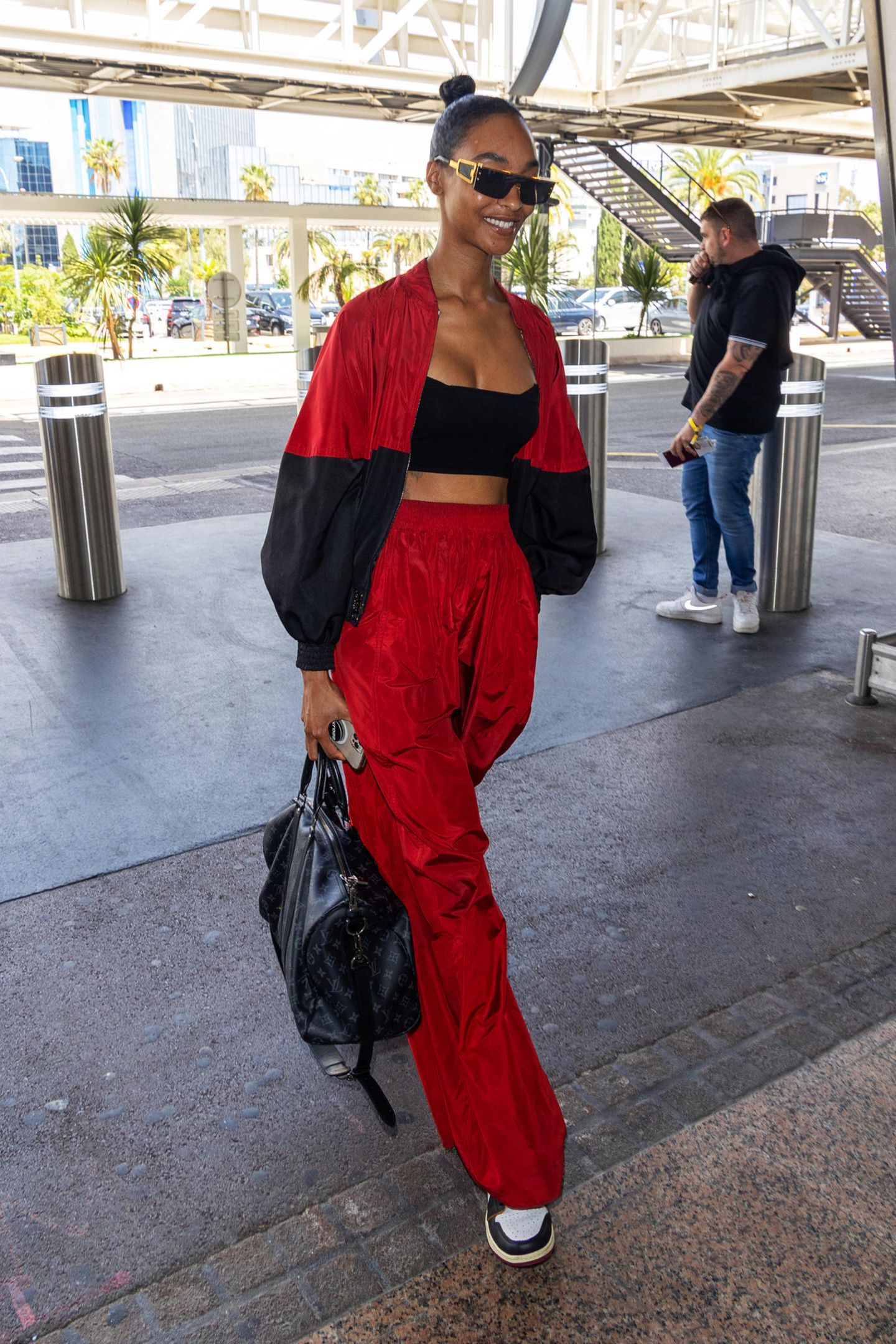 Stylisch und bequem: Topmodel Jourdan Dunn verabschiedet sich im schwarz-roten Blouson-Outfit von Cannes.