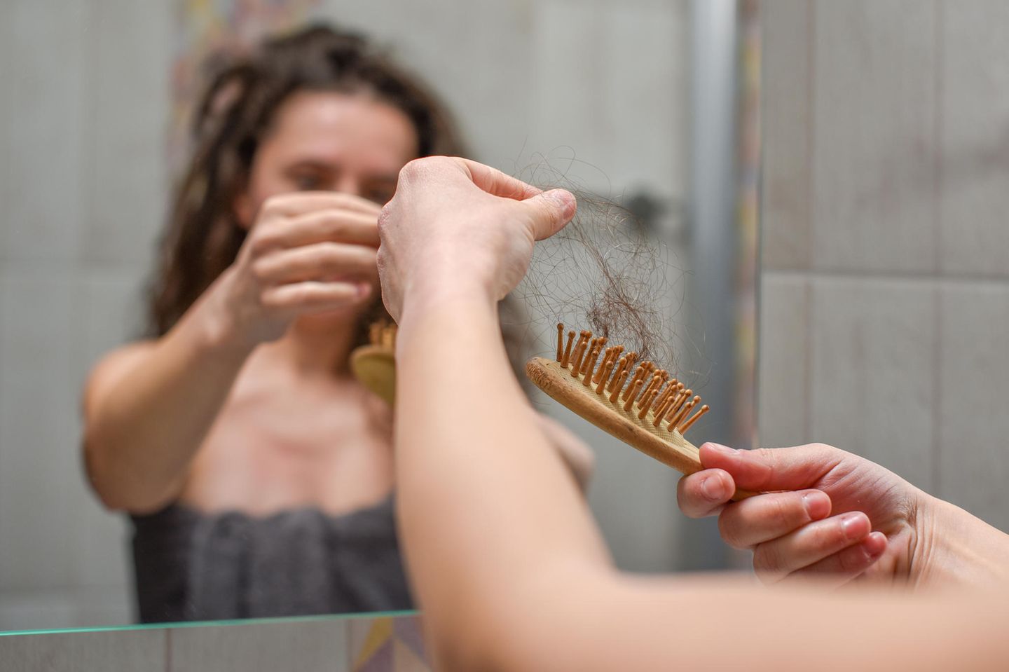 Rosmarinöl fürs Haar: Frau verliert Haarsträhnen durch Bürste