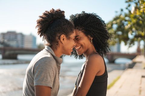 Beziehungstipps für die Generation Zwei Frauen lächeln sich an und halten die Köpfe aneinander