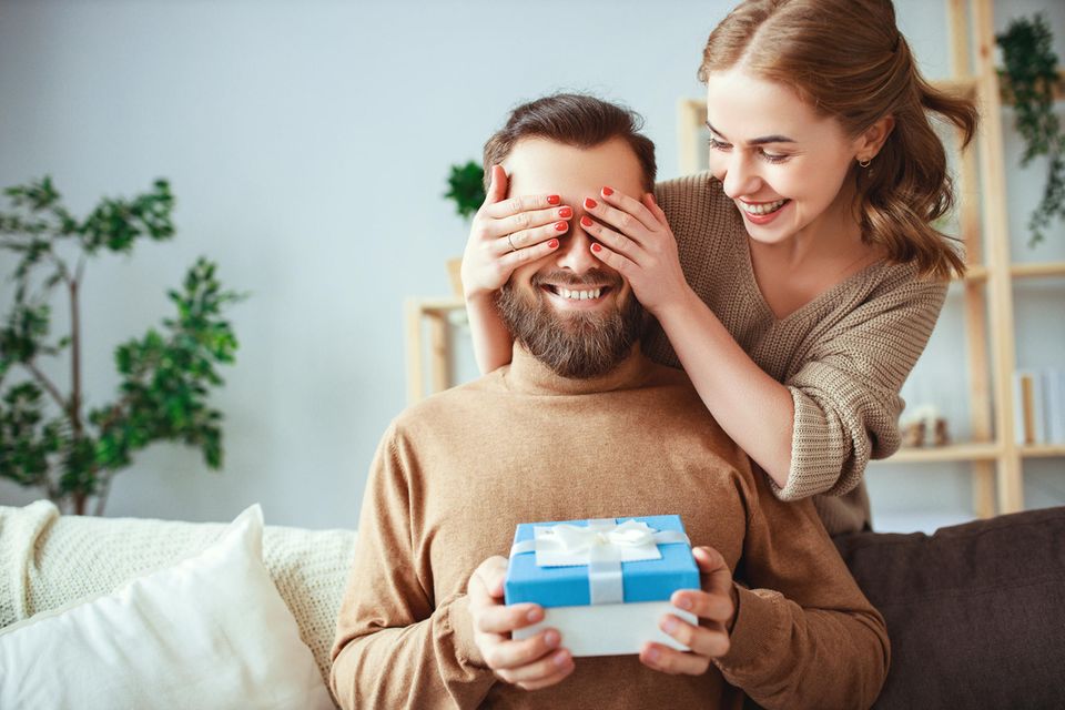 Frau überreicht Geschenk, glückliches Paar, nachhaltige Geschenke