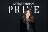 Zu Gast bei der Giorgio Armani Price Haute Couture Show zeigt sich Carla Bruni in einer schicken Anzugshose und einem samtigen Jackett. Darunter trägt sie einen tiefen Ausschnitt mit Netzstoff.