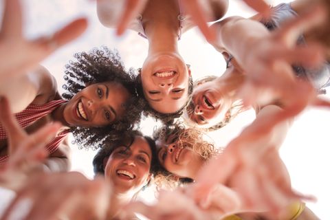 Eine Gruppe Frauen steht lachend in einem Kreis