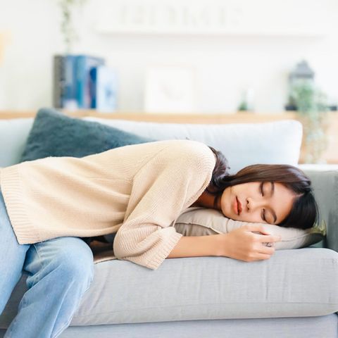 Frau schläft auf der Couch: Das passiert, wenn du täglich einen Mittagsschlaf machst