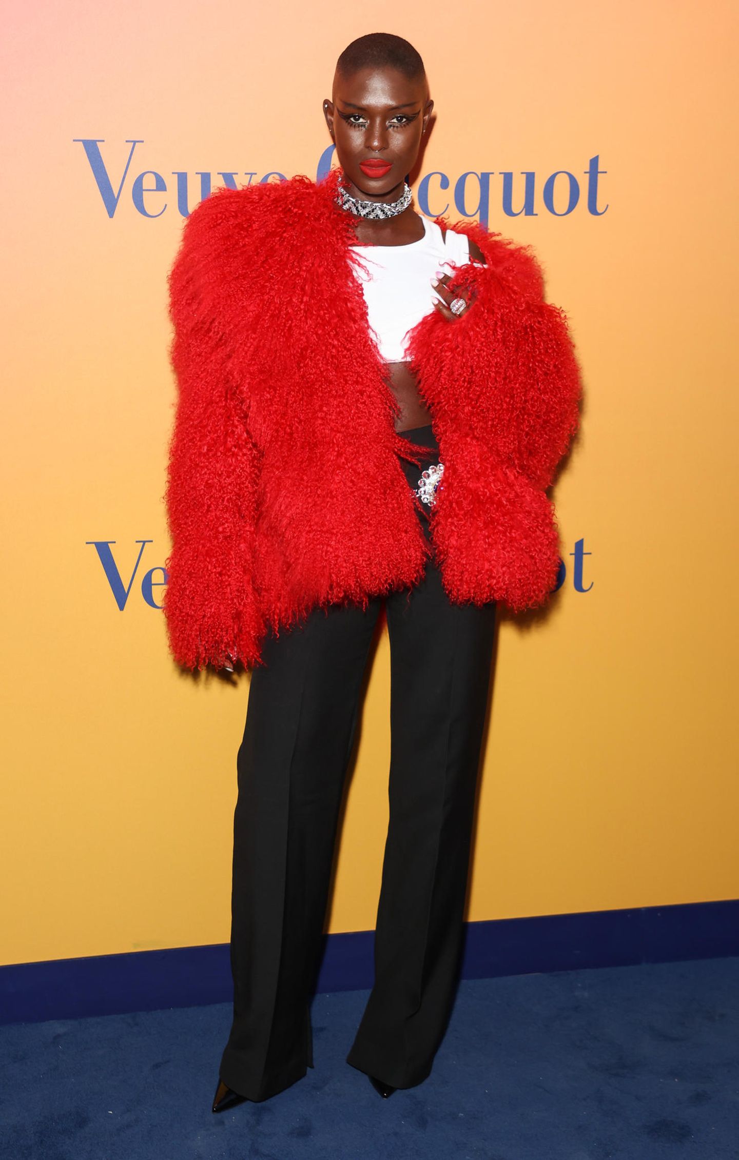 Mit dieser flauschigen Jacke setzt sie ein Fashion-Statement: Bei der Eröffnung des Veuve Clicquot's Solaire Culture in London begeistert Schauspielerin Jodie Turner-Smith in lebhafter Farbe. Um ihrer Jacke mehr Ausdruck zu verleihen, besteht die Basis ihres Looks aus Basics. 