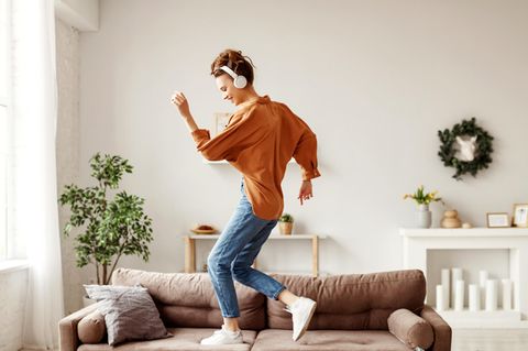 Hauhalt: Eine Frau tanzt auf der Couch