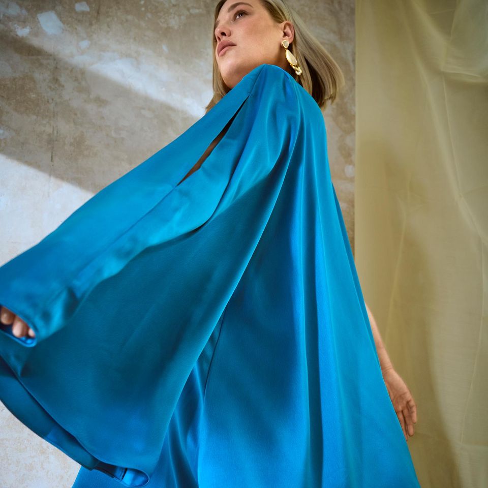 Ein Traum in Blau – in diesem verspielten Kleidchen ziehst du garantiert alle Blicke auf dich. Asymmetrisches Minikleid mit einem weitem Ärmel: Jarlo Curve/Zalando, ca. 245 Euro, Spiegelohrringe Aurélie Bidermann. 