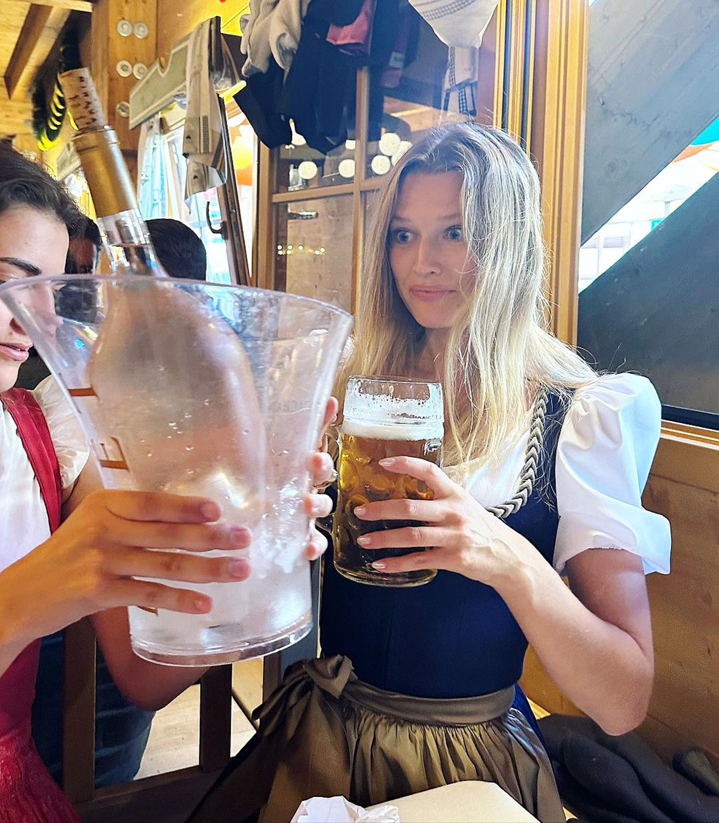 Toni Garrn will sich auch dem Oktoberfest von ihrem Besuch der Fashion Week in Paris erholen und probiert dort ihr erstes Bier, obwohl sie Wein bevorzugt. Wenn schon nicht ganz das richtige Getränk, den richtigen Wiesn-Look trägt sie auf jeden Fall. Die weiße Bluse und dazu ein dunkelblaues Dirndl mit mattgoldener Schürze stehen dem Topmodel hervorragend.