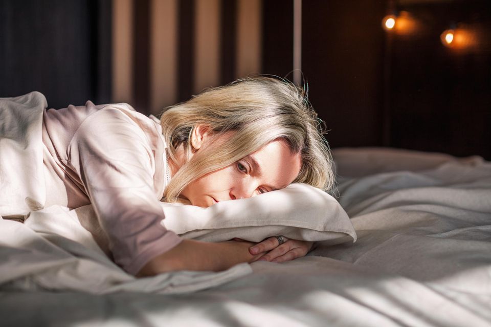 Psychologie: Eine müde Frau im Bett