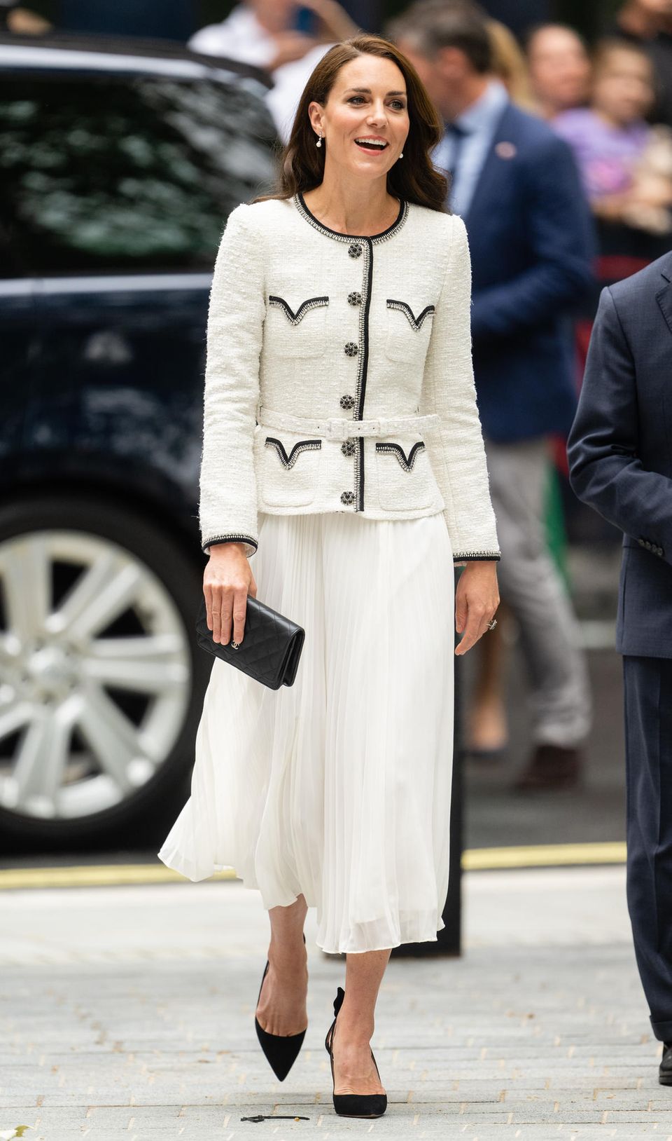 Catherine, Princess of Wales, still seems to love the bouclé-chiffon combination. The dress, with its contrasting black decorative stitching, is from Self-Portrait and strongly resembles Diana's look.